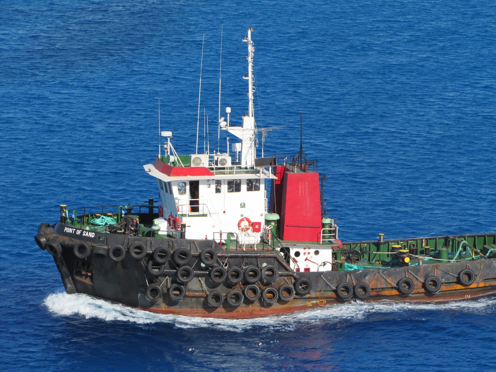 A harbor tug alongside as we left George Town