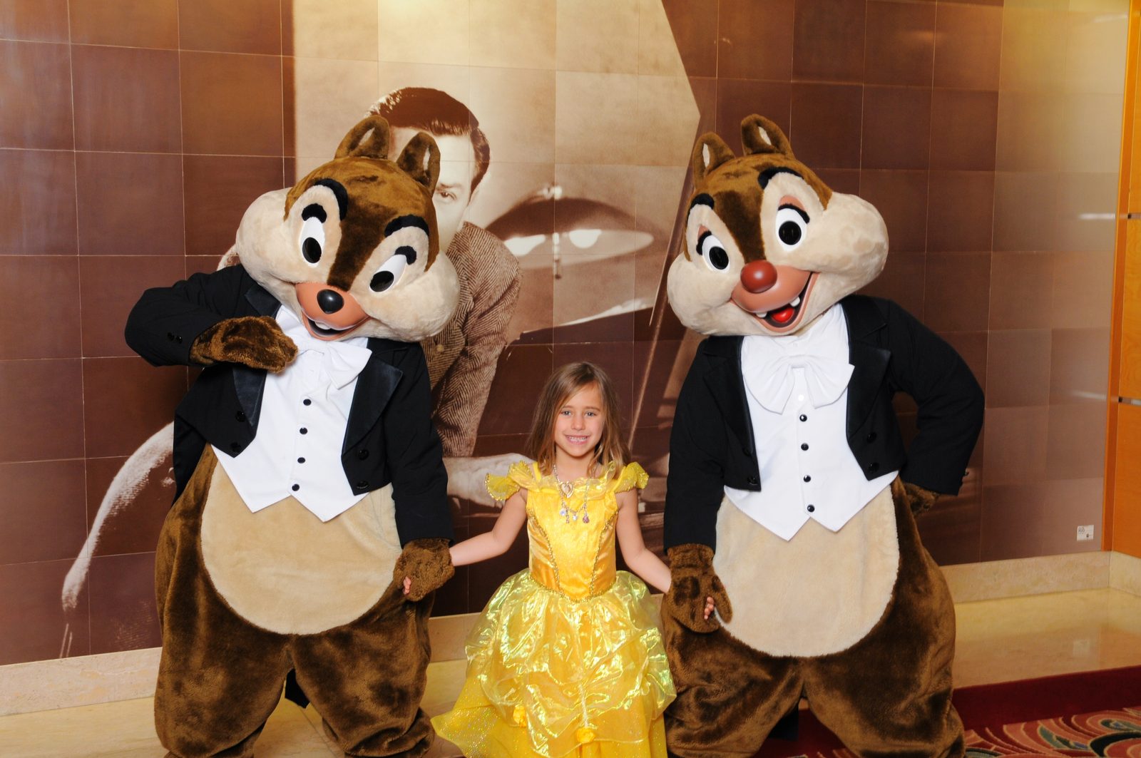 Chip and Dale in their Formal Night tuxedos with Lisa in her Belle dress in the Lobby Atrium