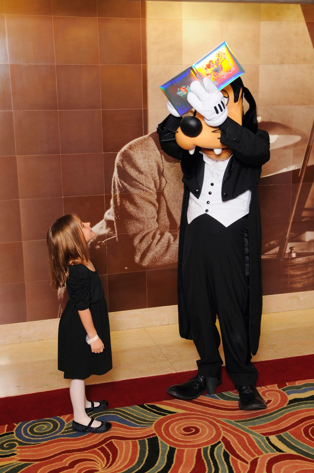 Lisa says hi to Goofy in his tuxedo in the Lobby Atrium