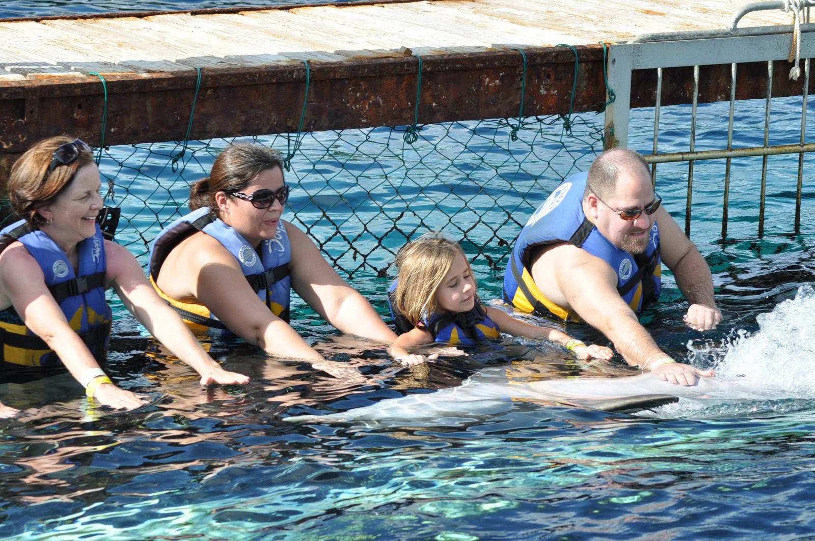 Swimming with dolphins together at Chankanaab