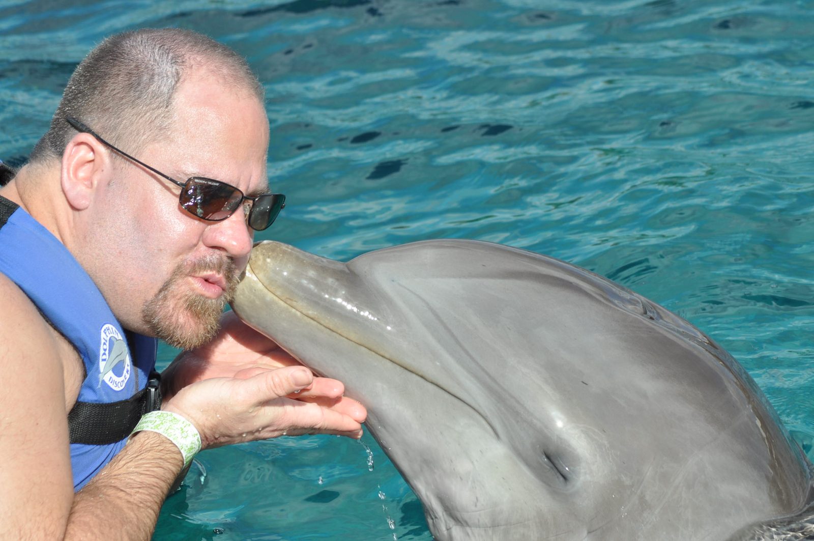 Michael getting a kiss from a dolphin at Chankanaab