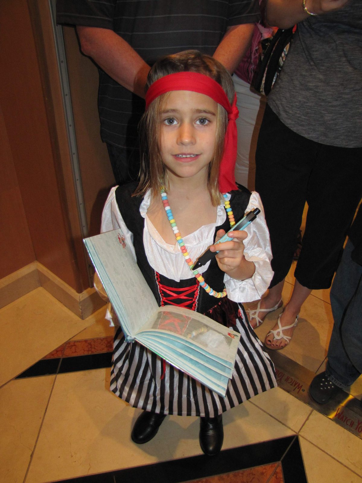 Lisa in her pirate costume with her autograph book