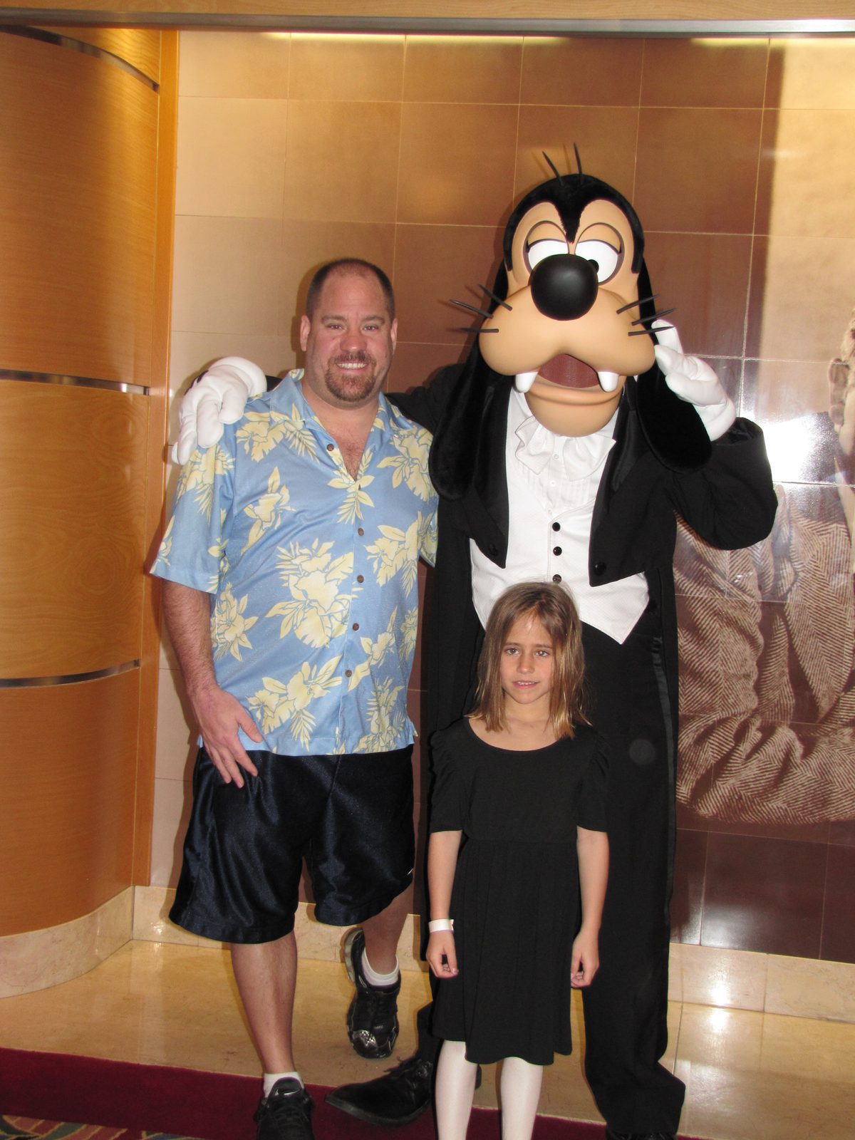 Michael, Lisa and Goofy in his tuxedo in the Lobby Atrium