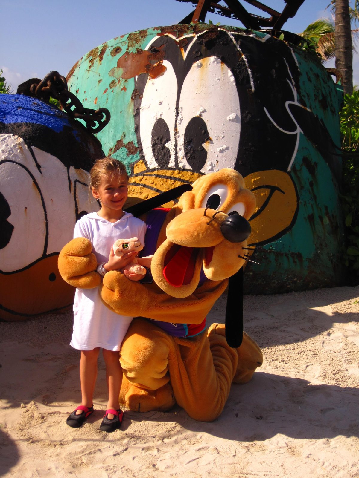 Lisa poses with Pluto on the beach