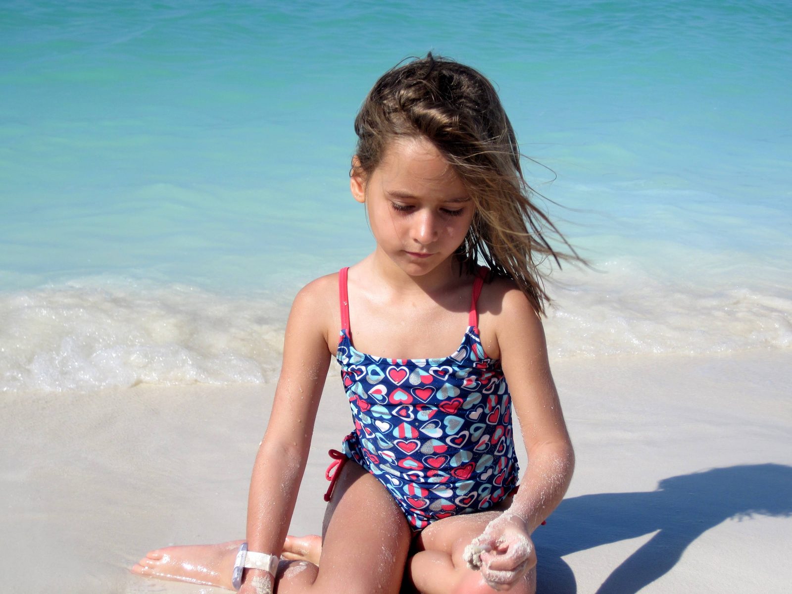 Lisa playing at the water's edge on Castaway Cay
