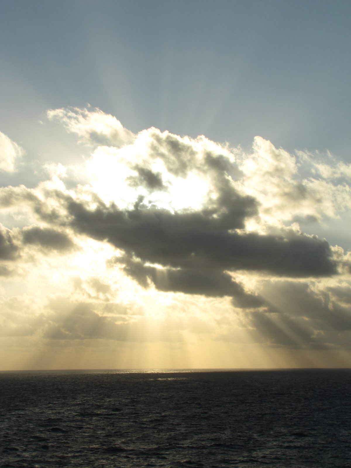 Sun rays breaking through the clouds off Cozumel