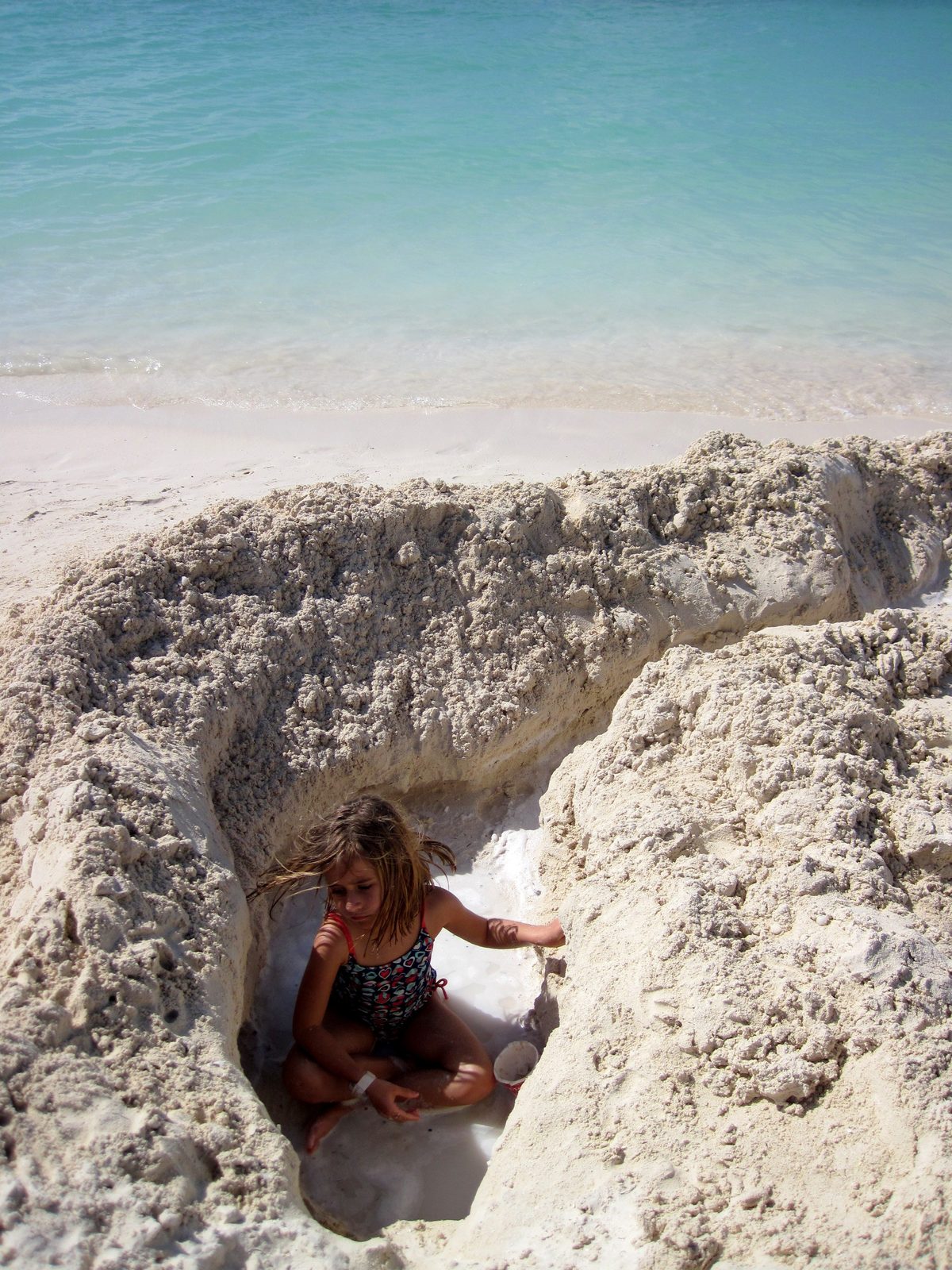Lisa sitting down in our hole on Castaway Cay