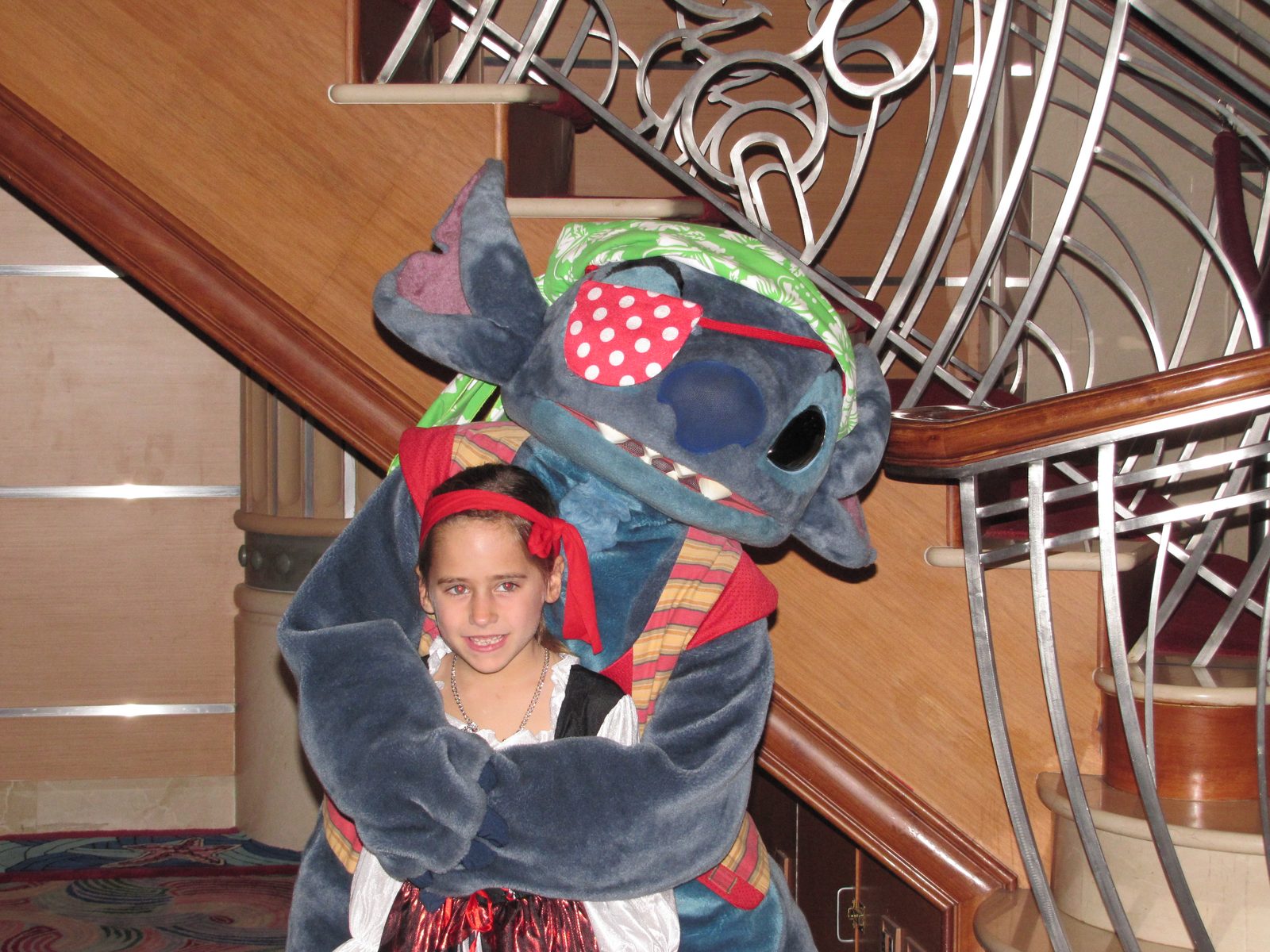 Lisa with Stitch in pirate garb on Pirate Night in the Lobby Atrium