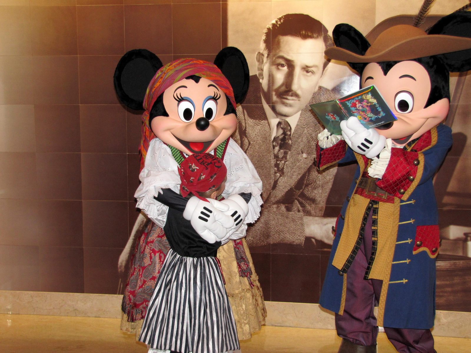 Lisa with Minnie and Mickey in pirate garb on Pirate Night in the Lobby Atrium