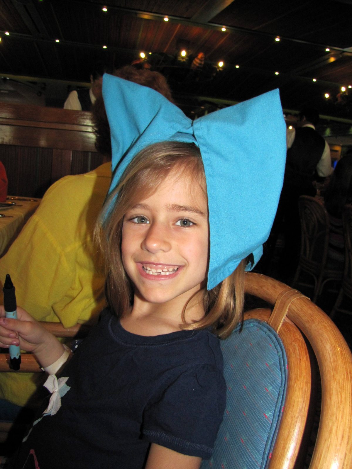 Lisa in her napkin hat at breakfast