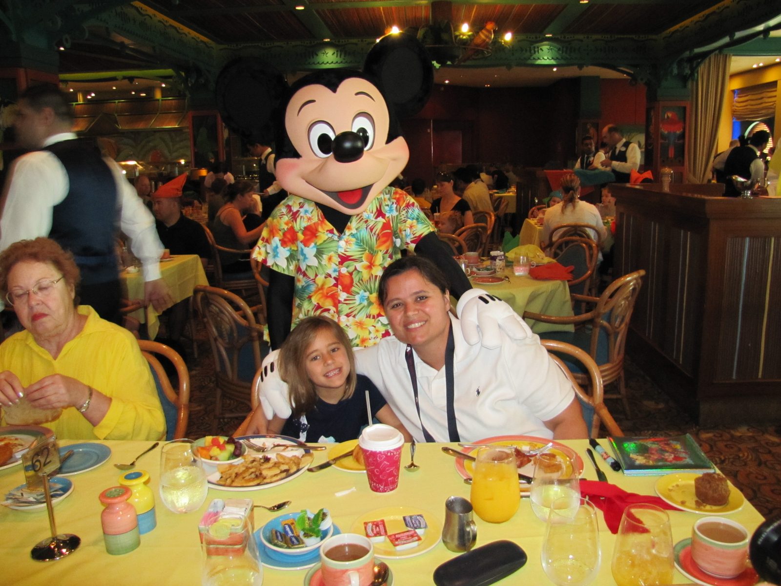 Lisa and Kathy with Mickey in his aloha shirt at the character breakfast