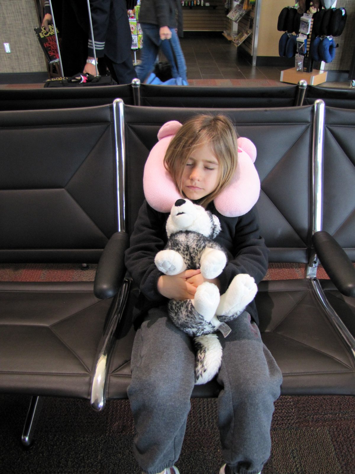 Lisa and Bob resting in the airport seats before the long travel day