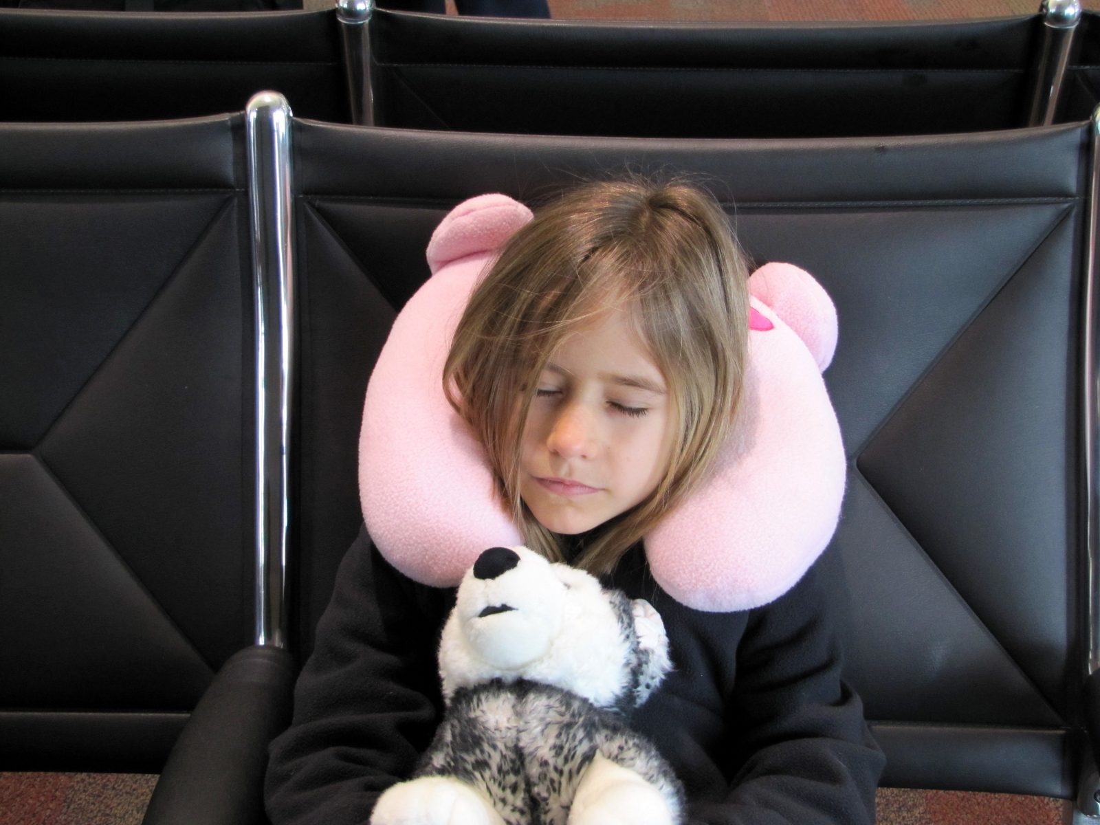 Lisa and her stuffed husky, Bob, waiting to board