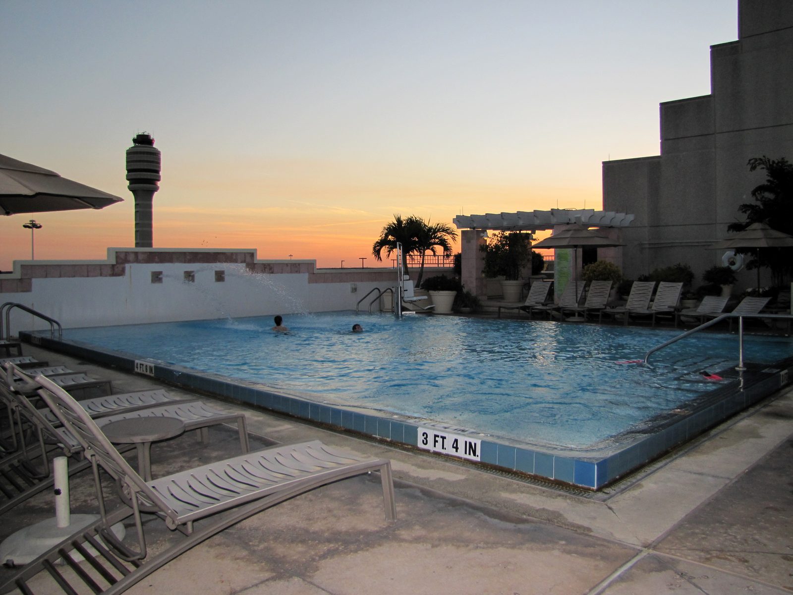 Sunset over the airport hotel pool
