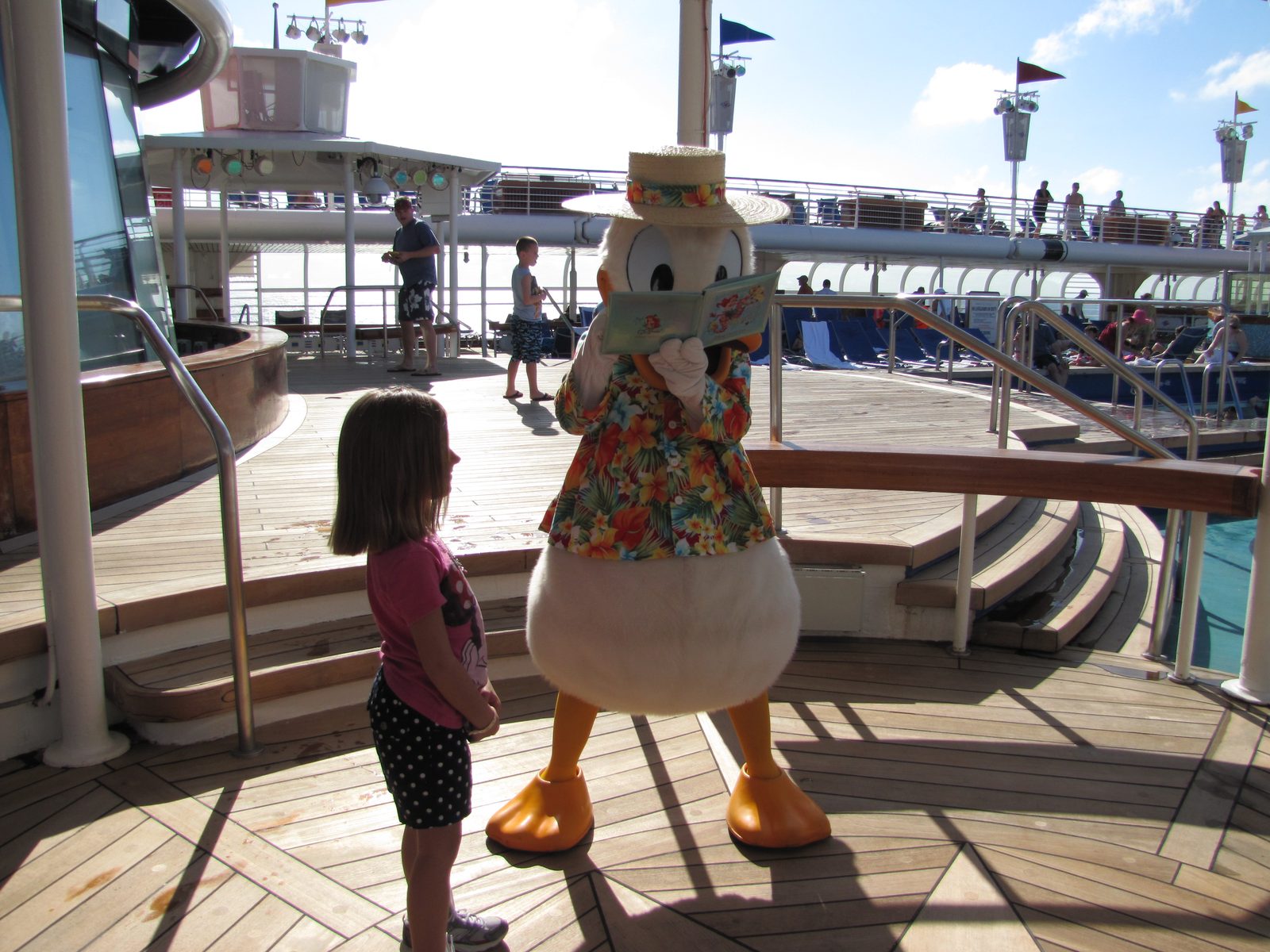 Lisa getting the autograph of Donald in his Hawaiian shirt and straw hat on the pool deck