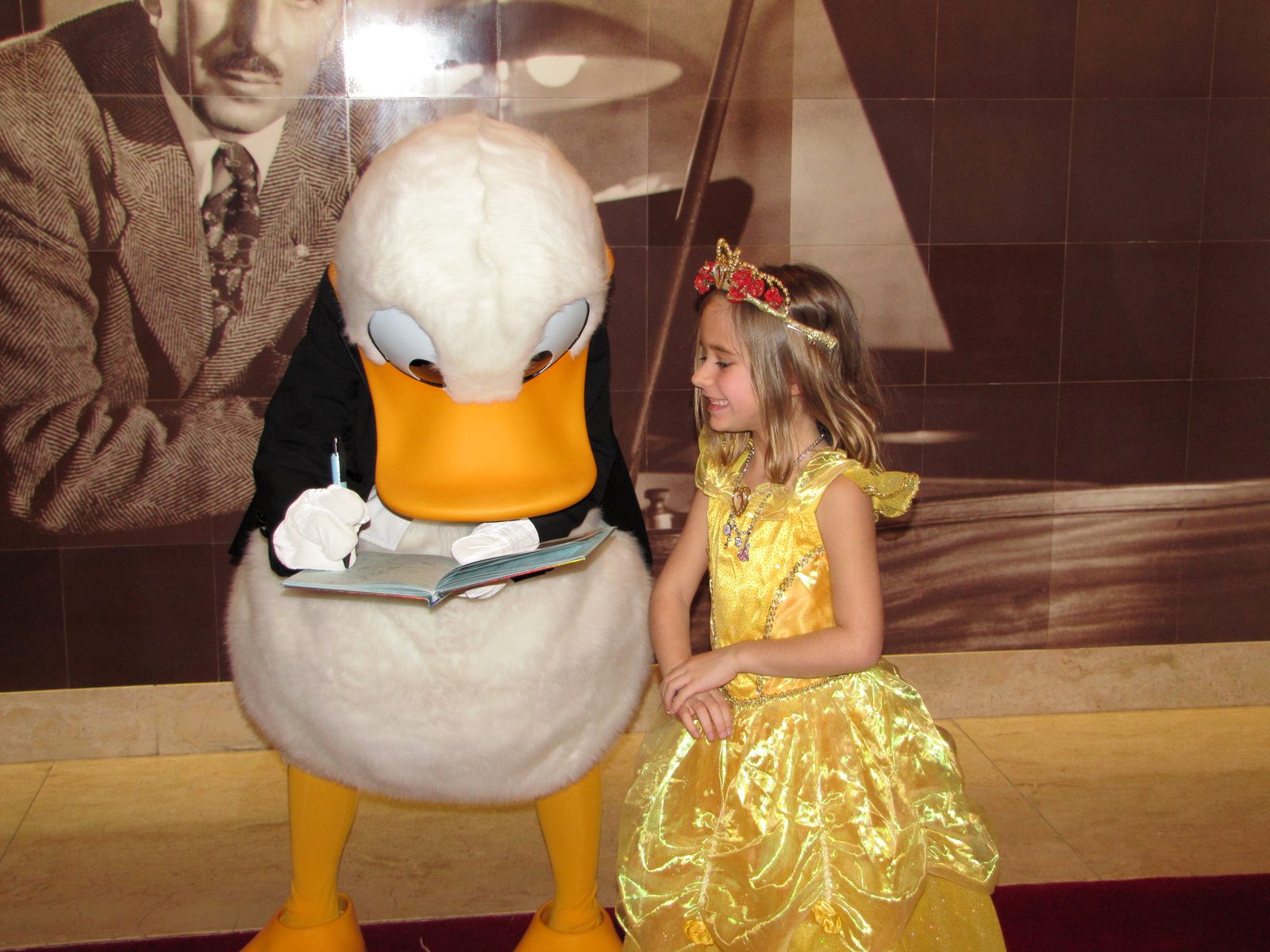 Donald in his tuxedo signs Lisa's autograph book on Formal Night in the Lobby Atrium