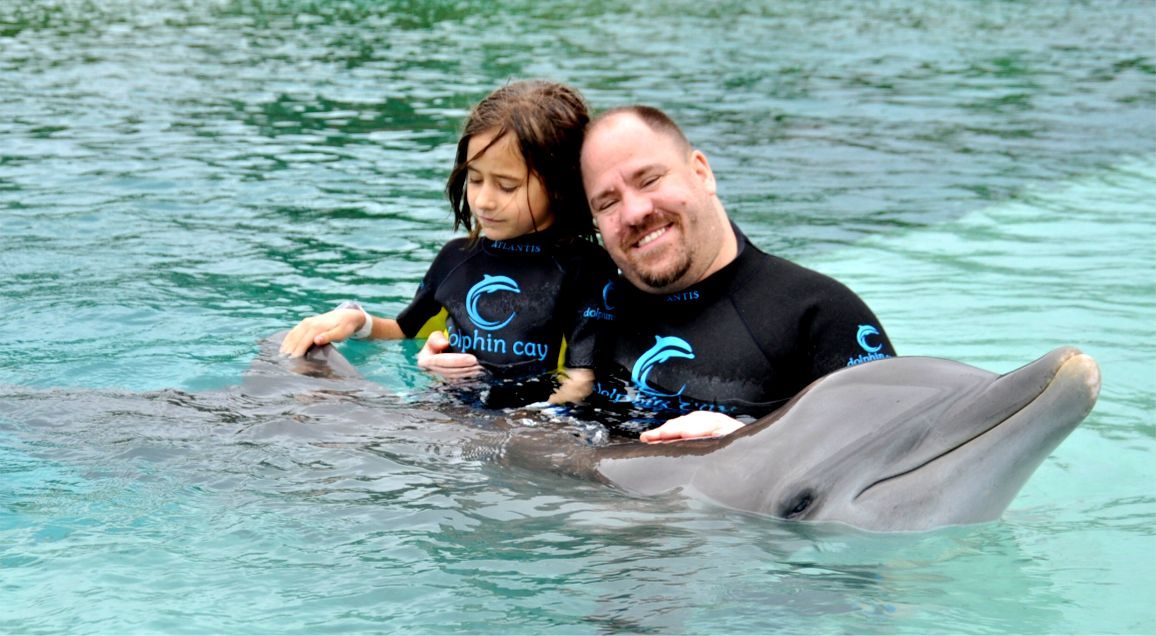 Holding Lisa as we met the dolphin