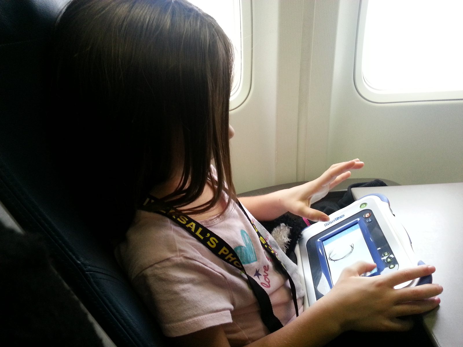 Lisa on her Innotab waiting to take off in Detroit