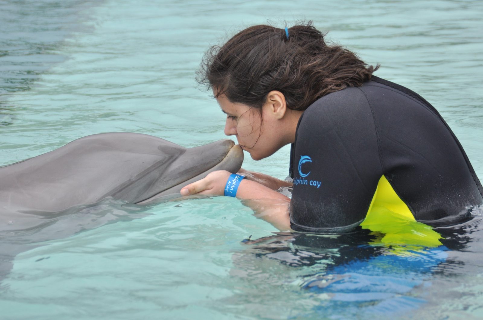 Kathy getting a dolphin kiss at Dolphin Cay