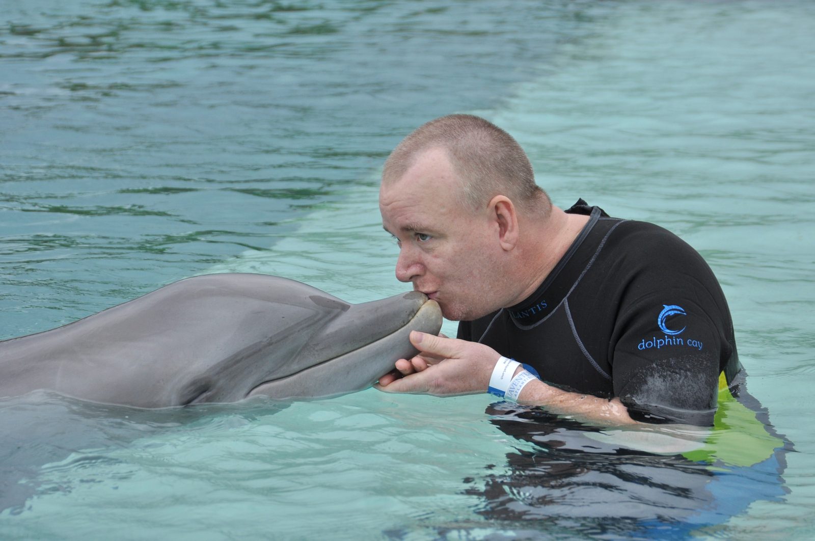 Dan getting a dolphin kiss at Dolphin Cay