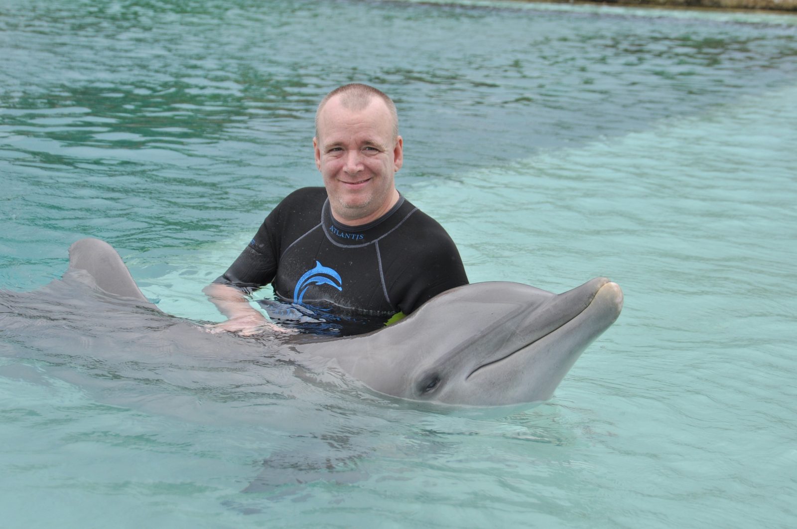 Dan with a dolphin at Dolphin Cay