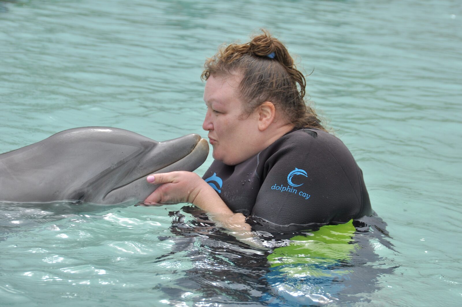 Kim's dolphin kiss at Dolphin Cay
