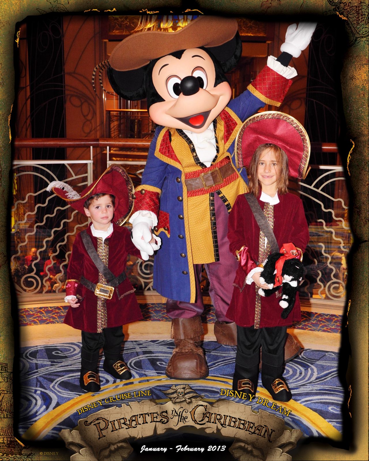 Thomas and Lisa with Mickey in pirate garb on Pirate Night in the Lobby Atrium