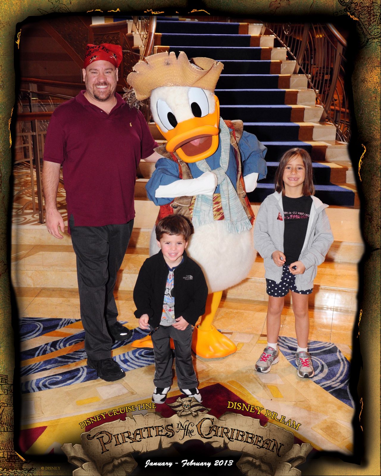 Michael, Thomas and Lisa with Donald in pirate garb on Pirate Night in the Lobby Atrium
