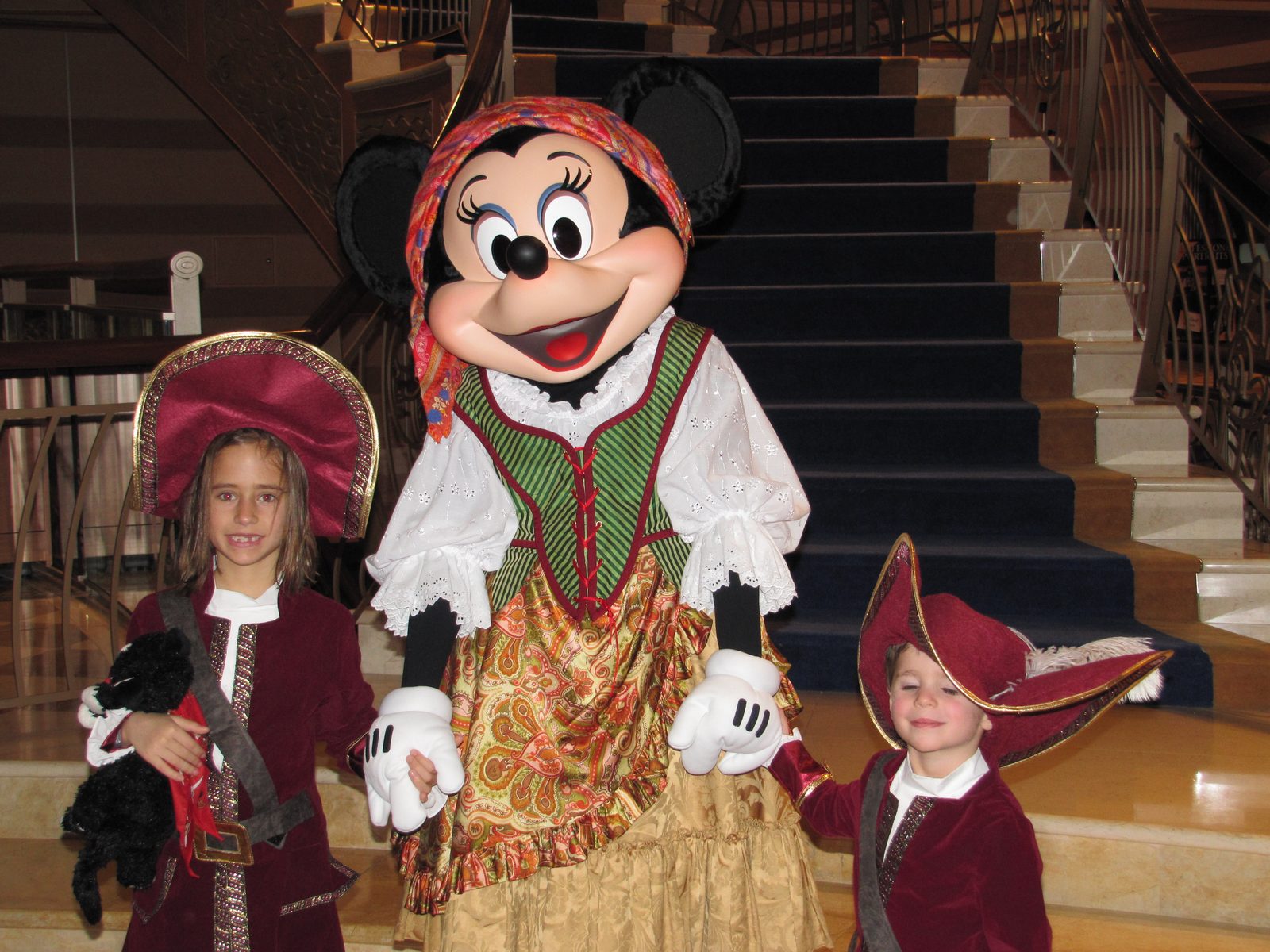 Lisa, Minnie in pirate garb and Thomas on Pirate Night in the Lobby Atrium
