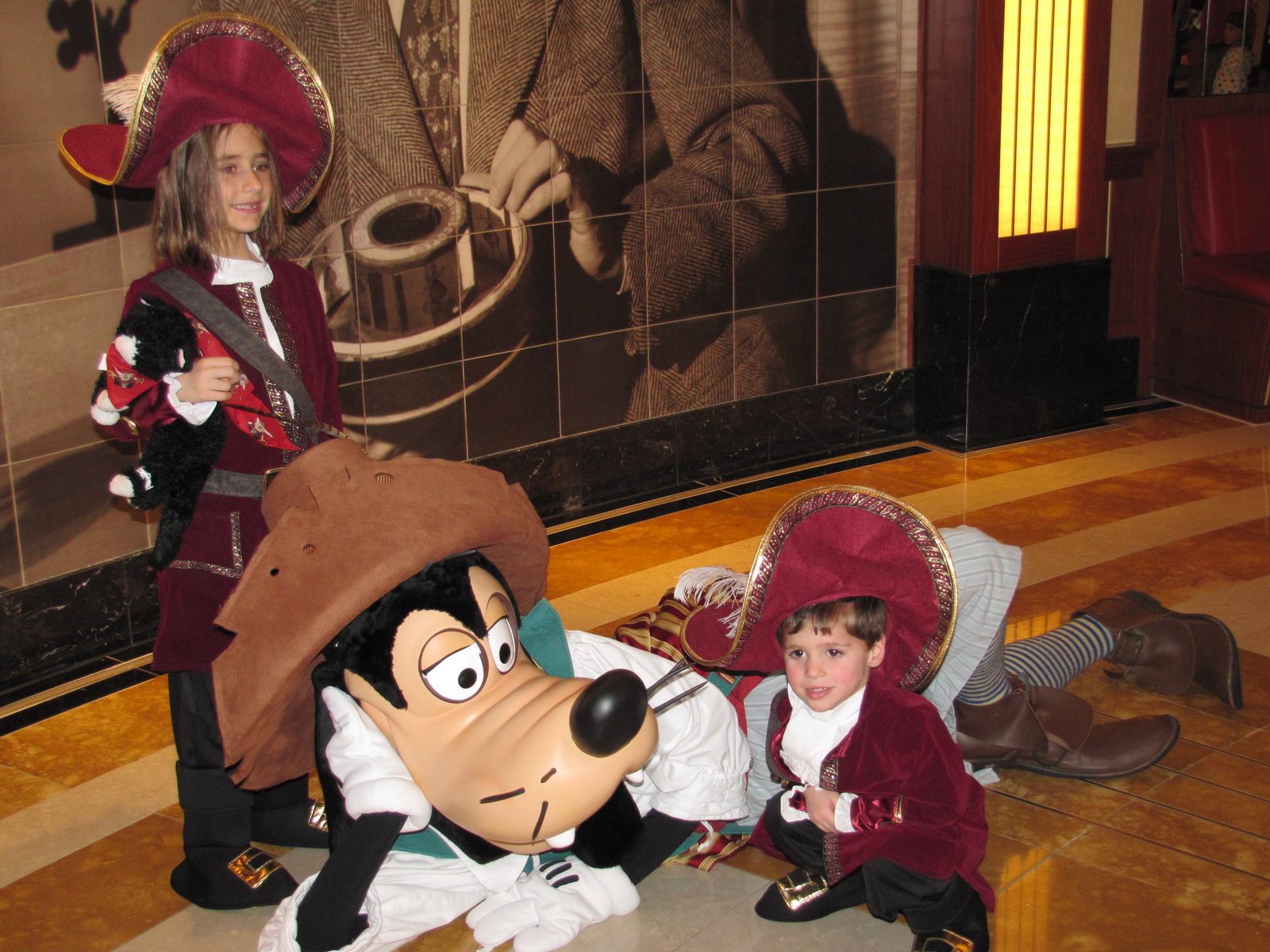 Lisa, Goofy in pirate garb and Thomas on Pirate Night in the Lobby Atrium