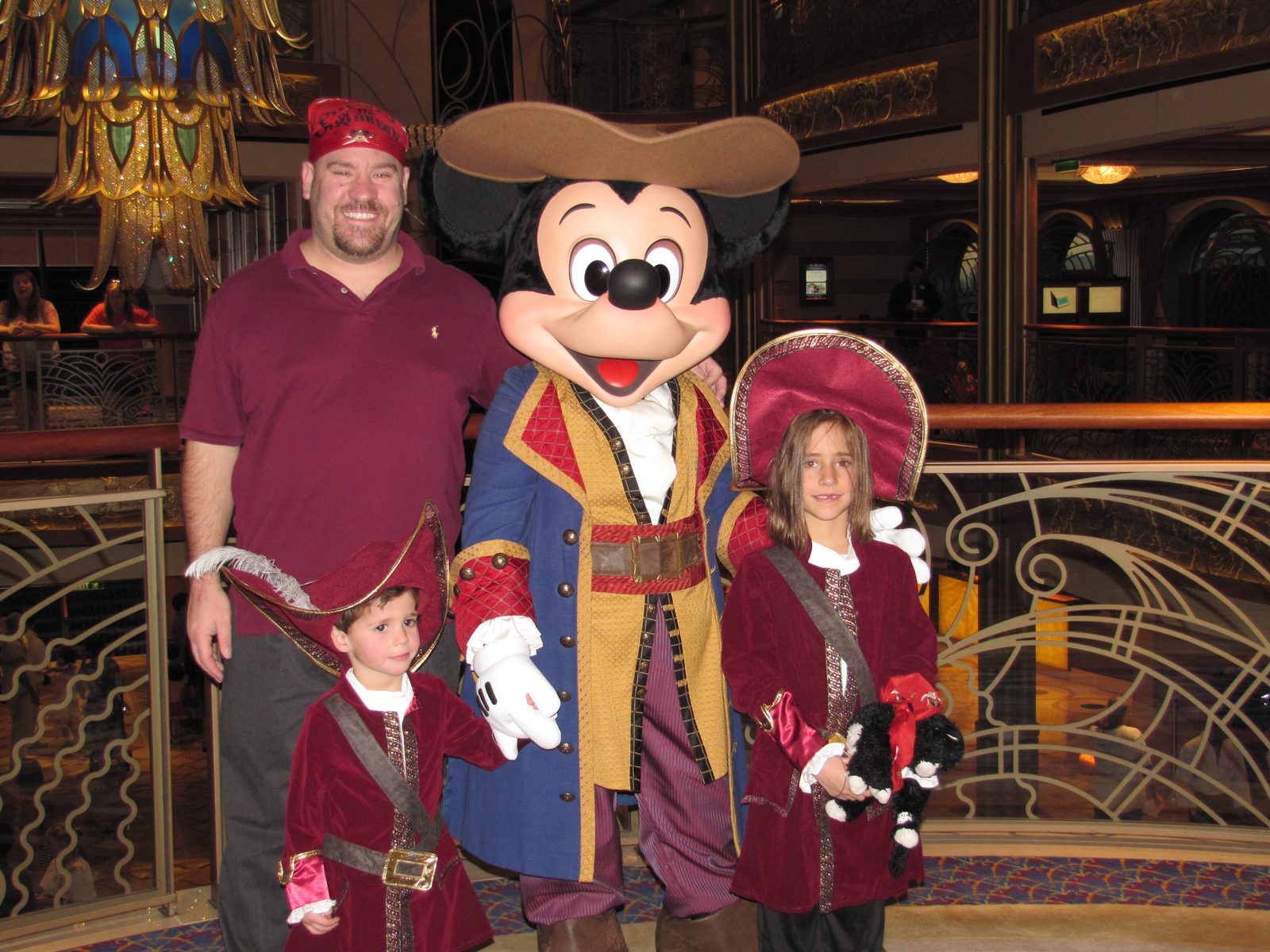 Michael, Thomas, Mickey in pirate garb and Lisa on Pirate Night in the Lobby Atrium