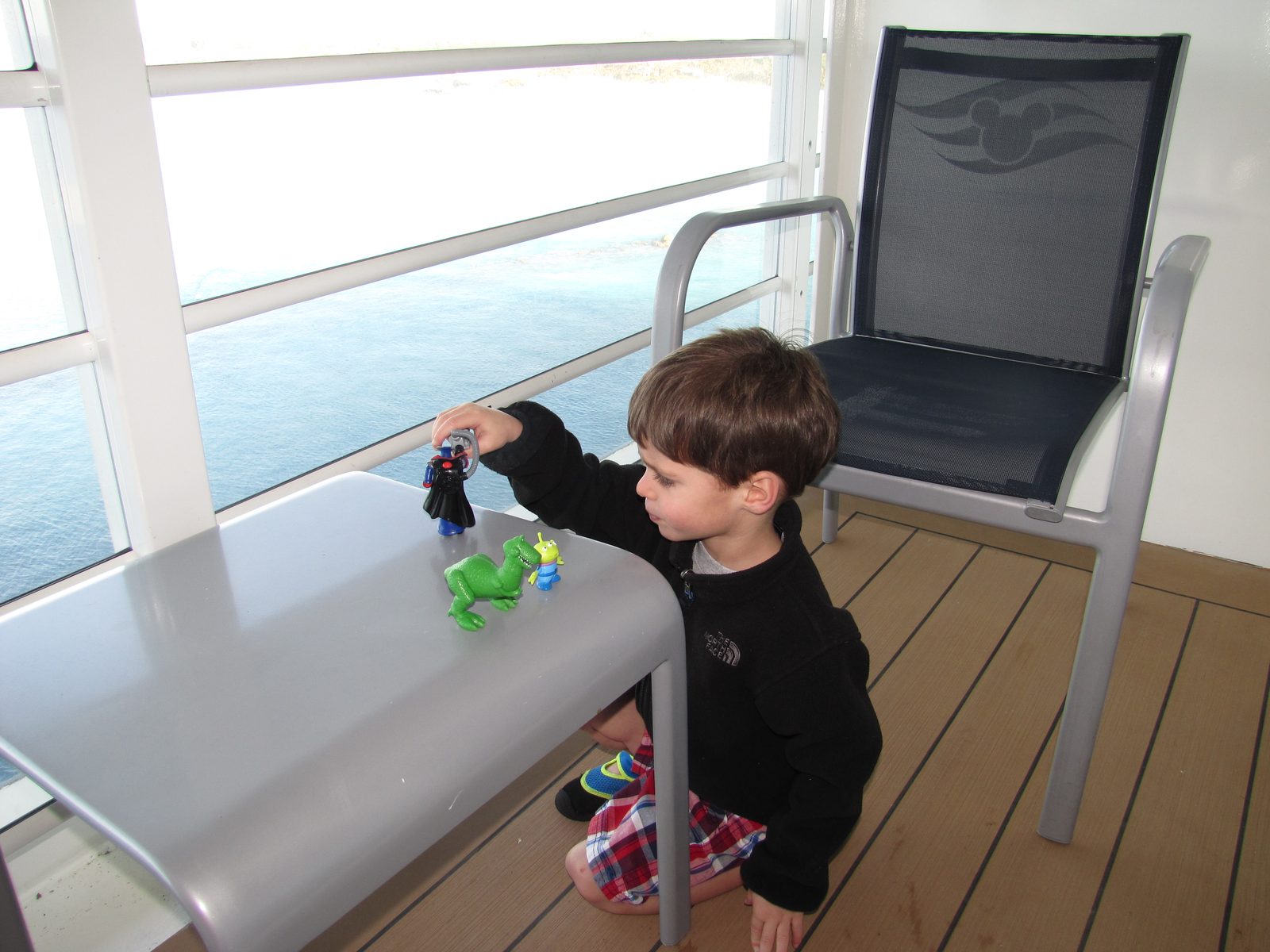 Thomas playing with his Toy Story figures on our balcony