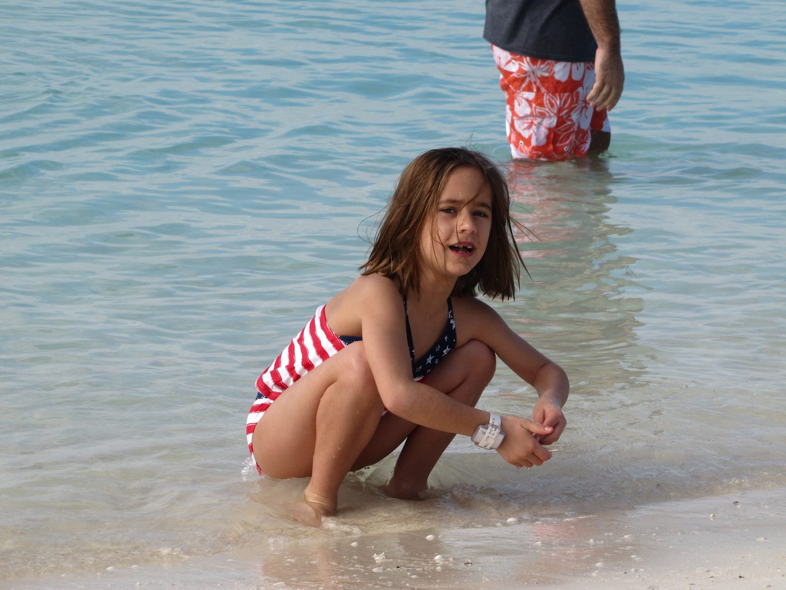 Lisa playing at the water's edge