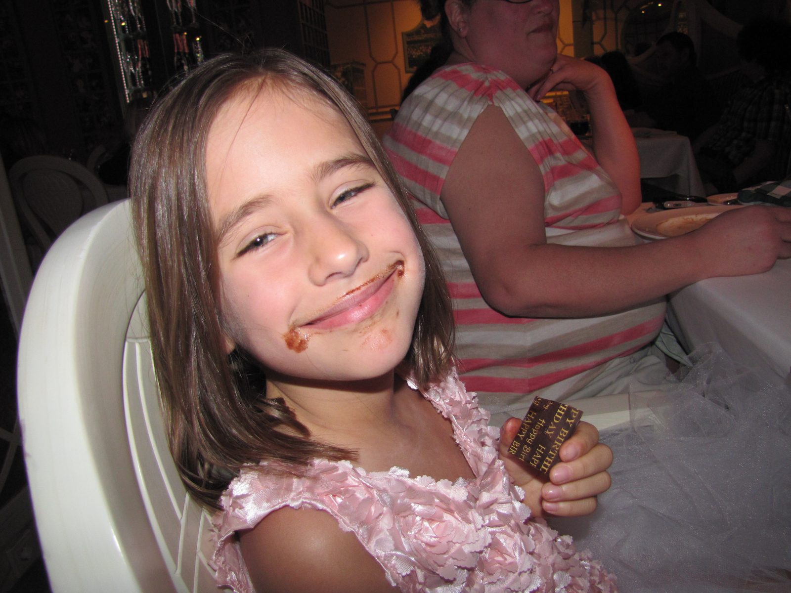 Lisa with chocolate all over her face at dinner