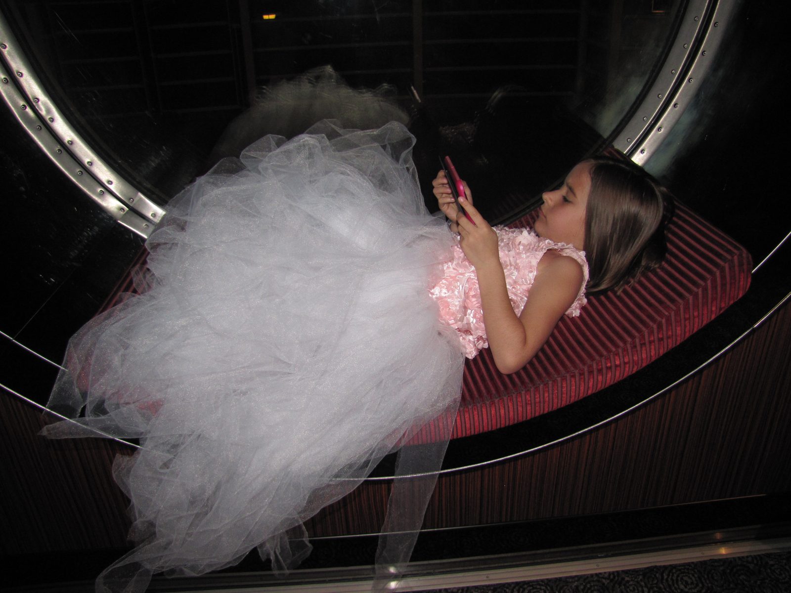 Lisa in the window playing her Kindle Fire