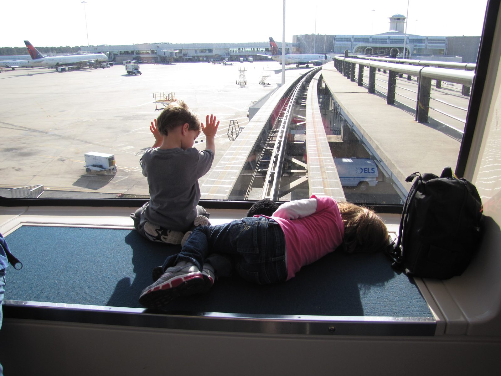 Tired but happy kids on the Orlando airport tram