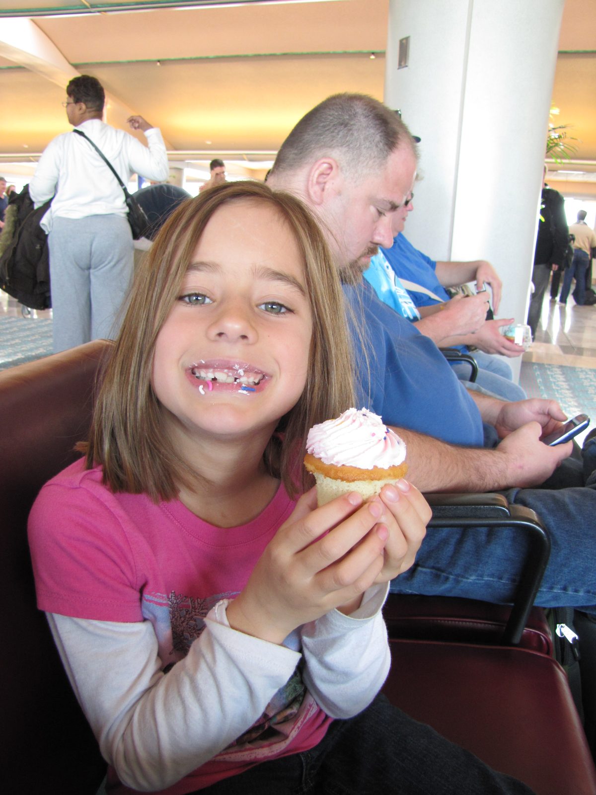 Lisa with a cupcake while we waited for our flight
