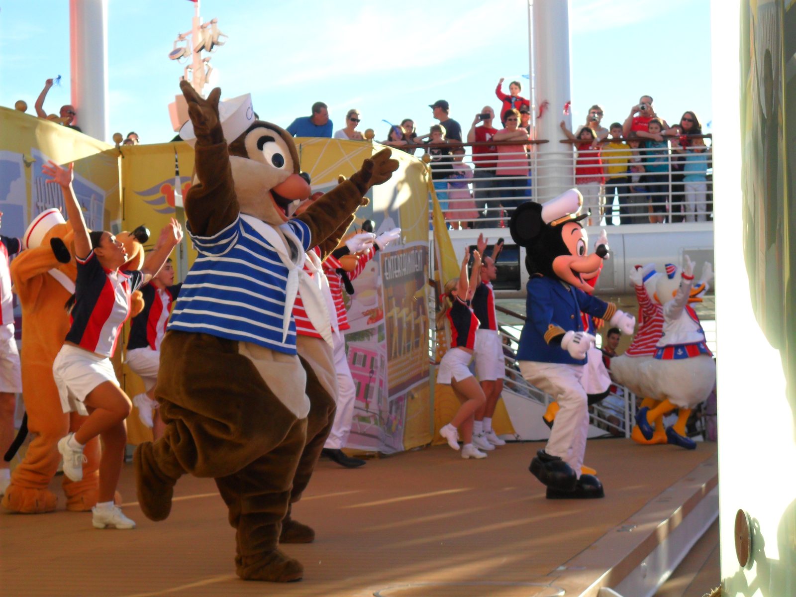 Pluto, Chip, Mickey and Donald in their sailor outfits dancing at the Sailing Away party