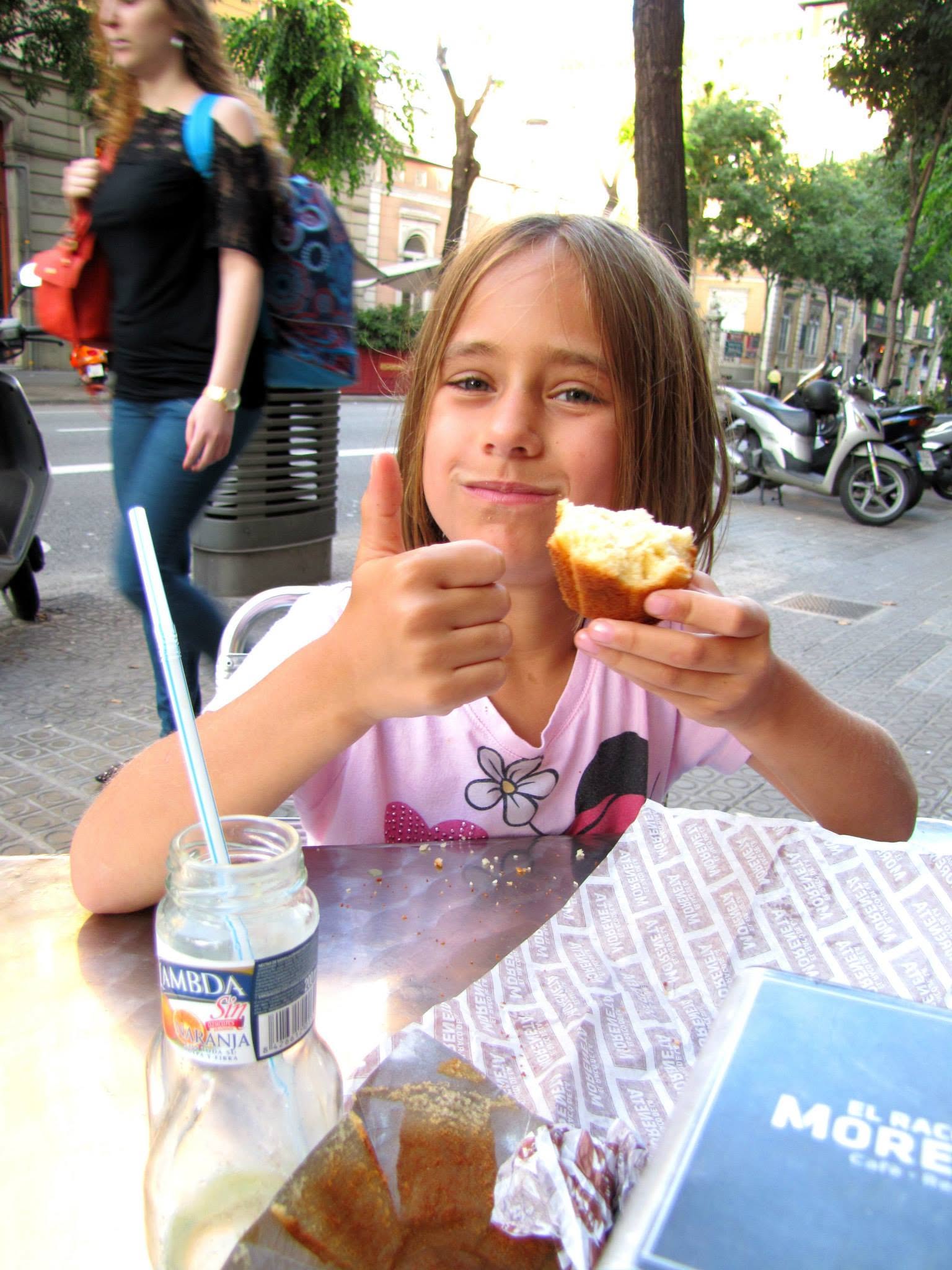 Lisa gives her muffin a thumbs up in Barcelona