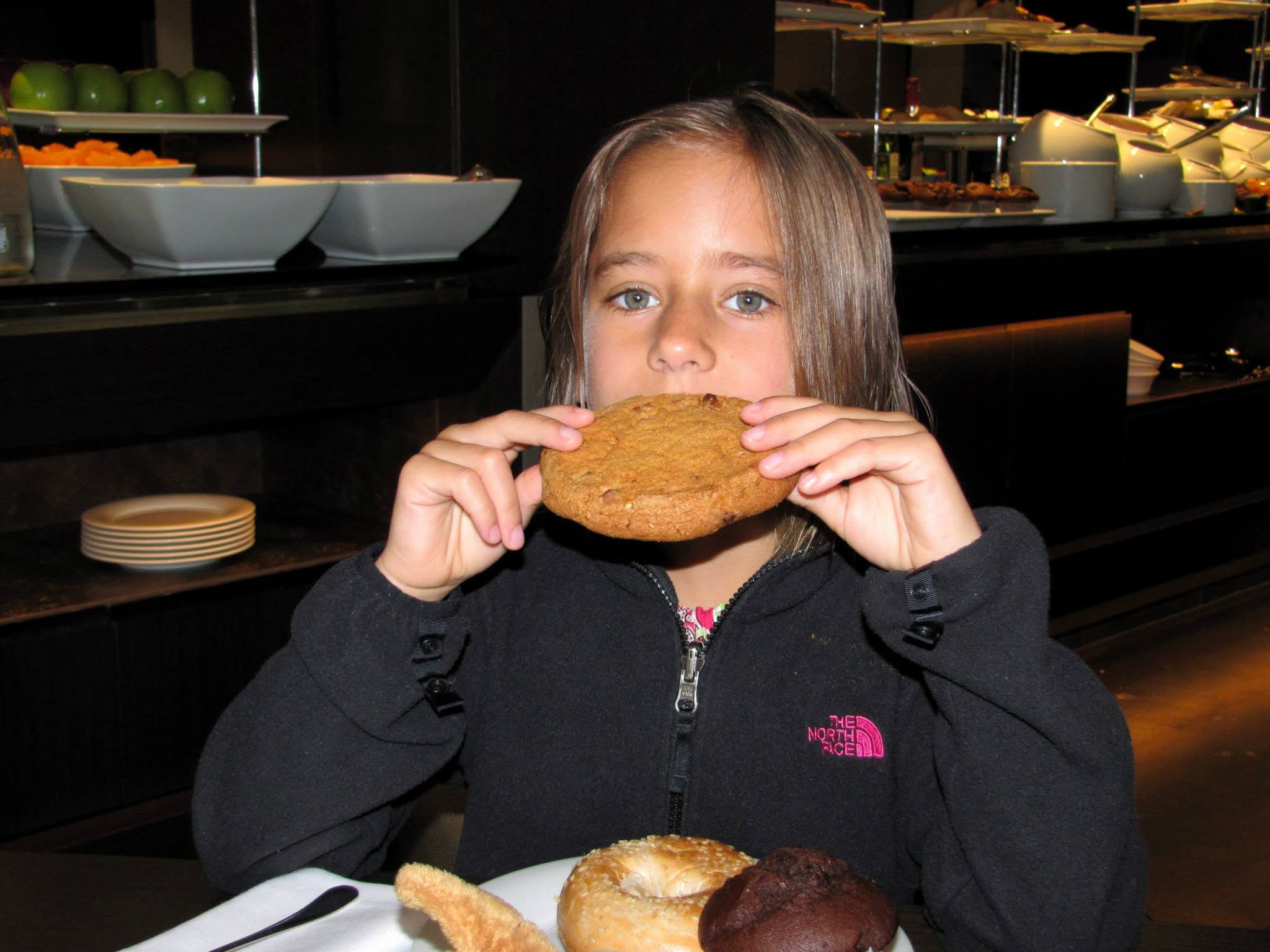 Lisa with a giant cookie at the hotel breakfast