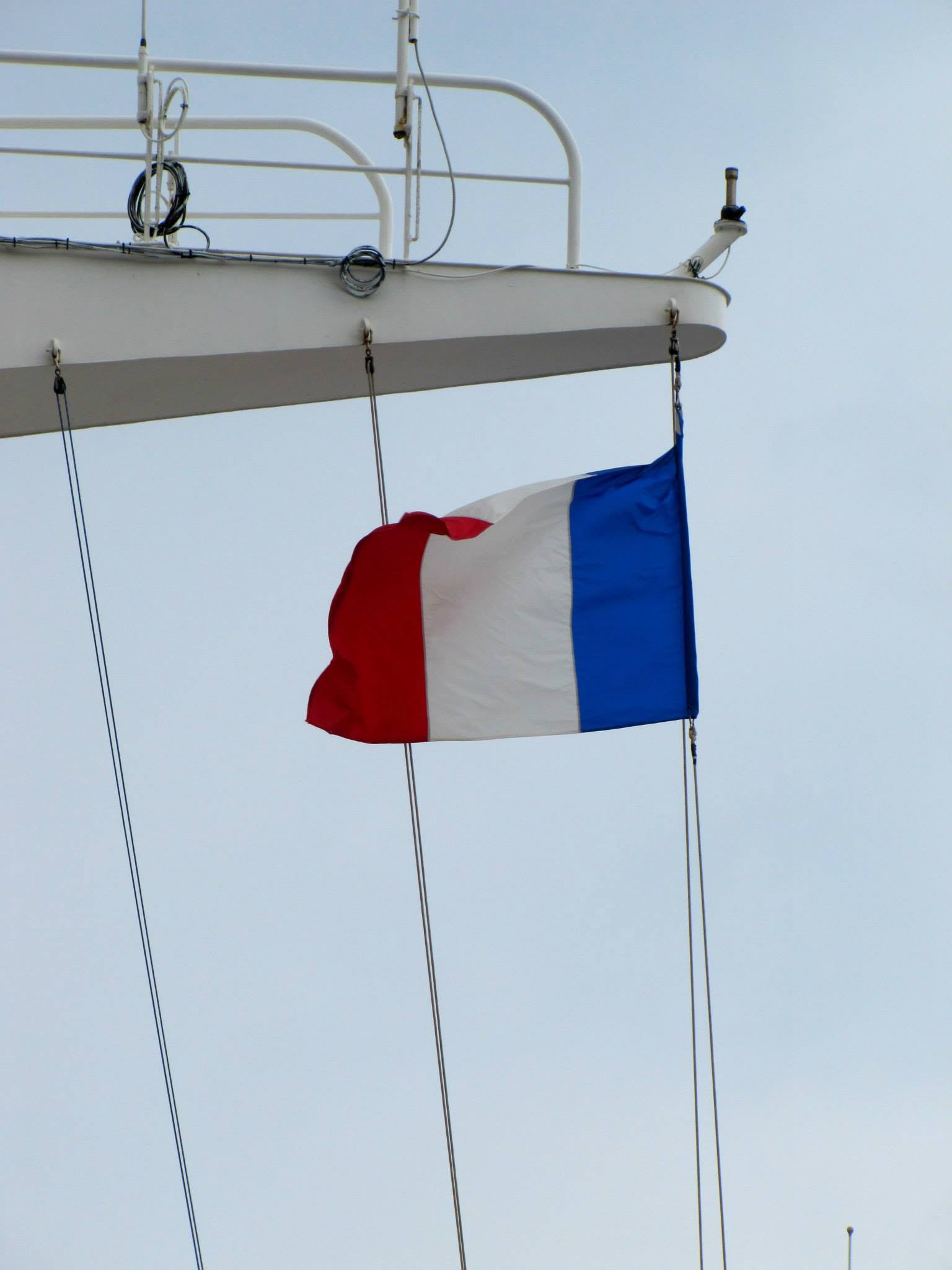 The French flag on the Magic's mast in port