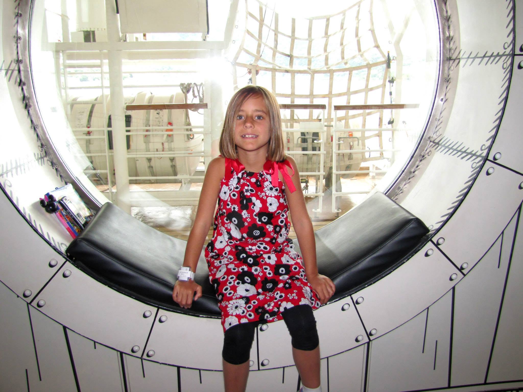 Lisa in the round window outside Animator's Palate