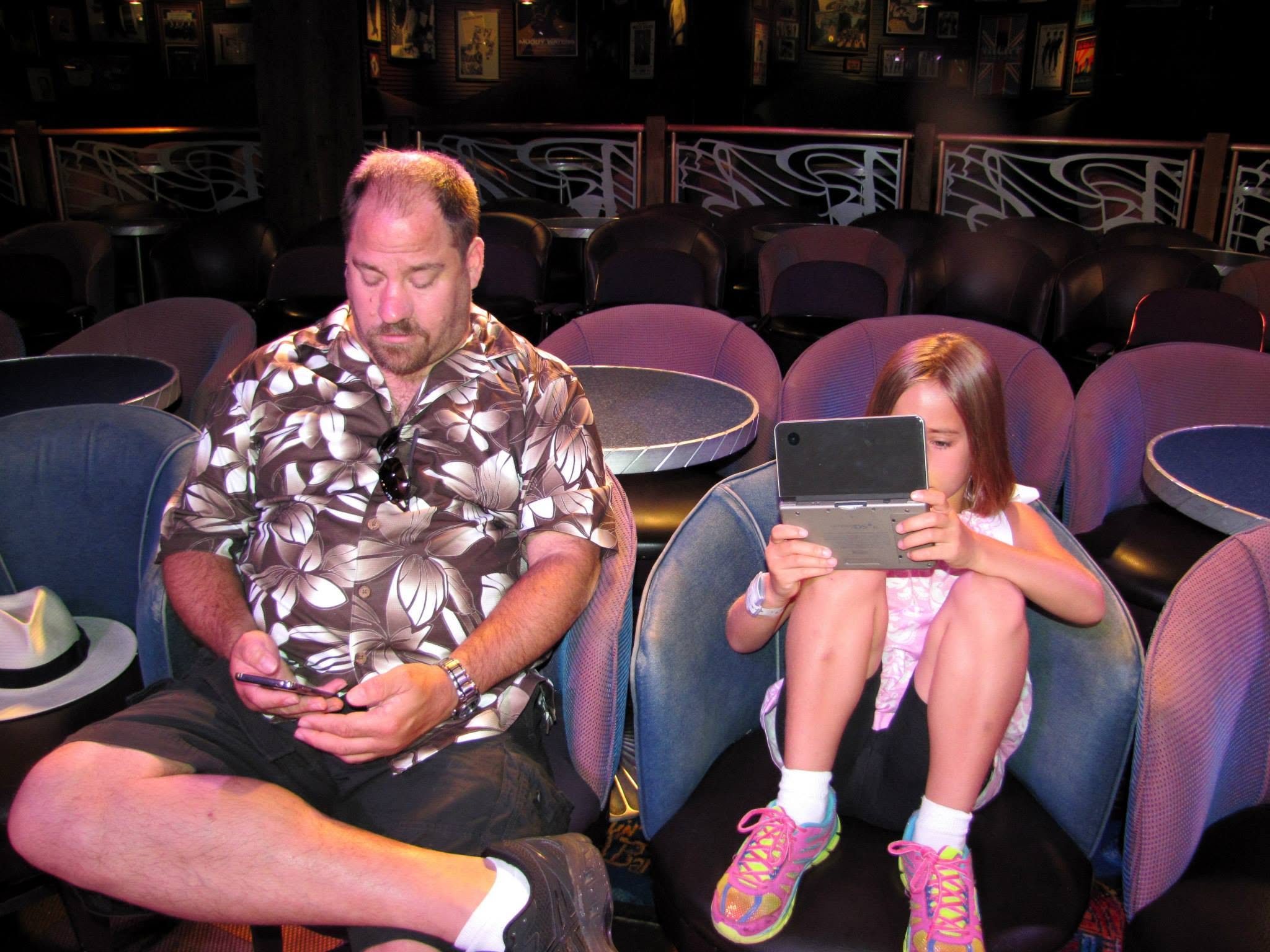 Lisa on her DS and Michael on his phone aboard the Magic