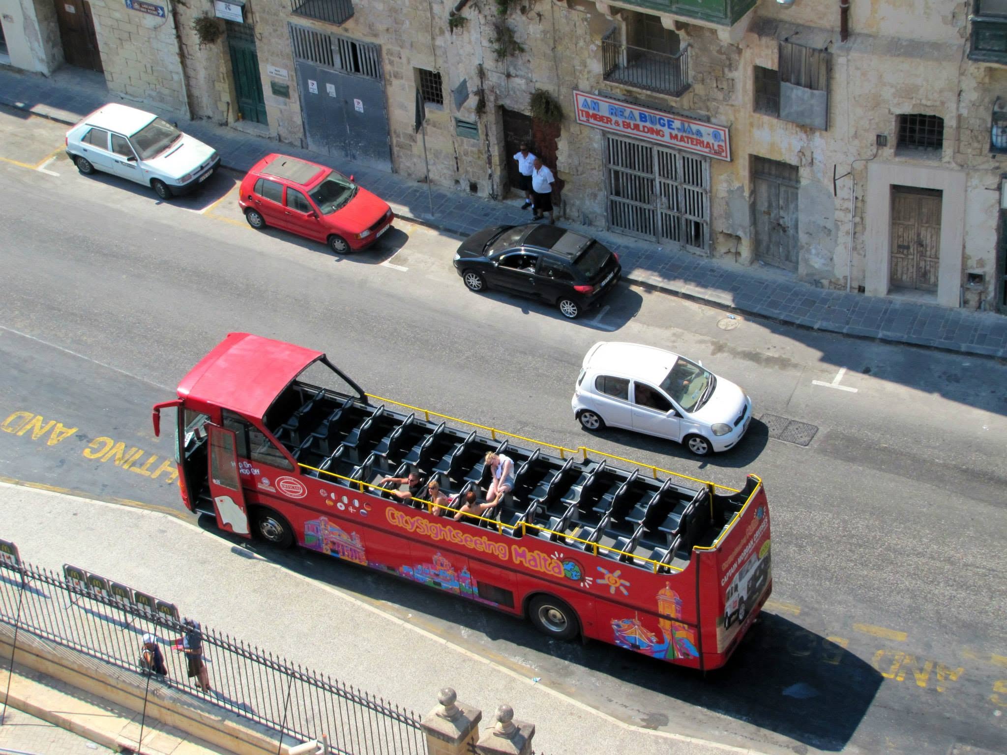 A hop-on hop-off bus below the ship in Valletta
