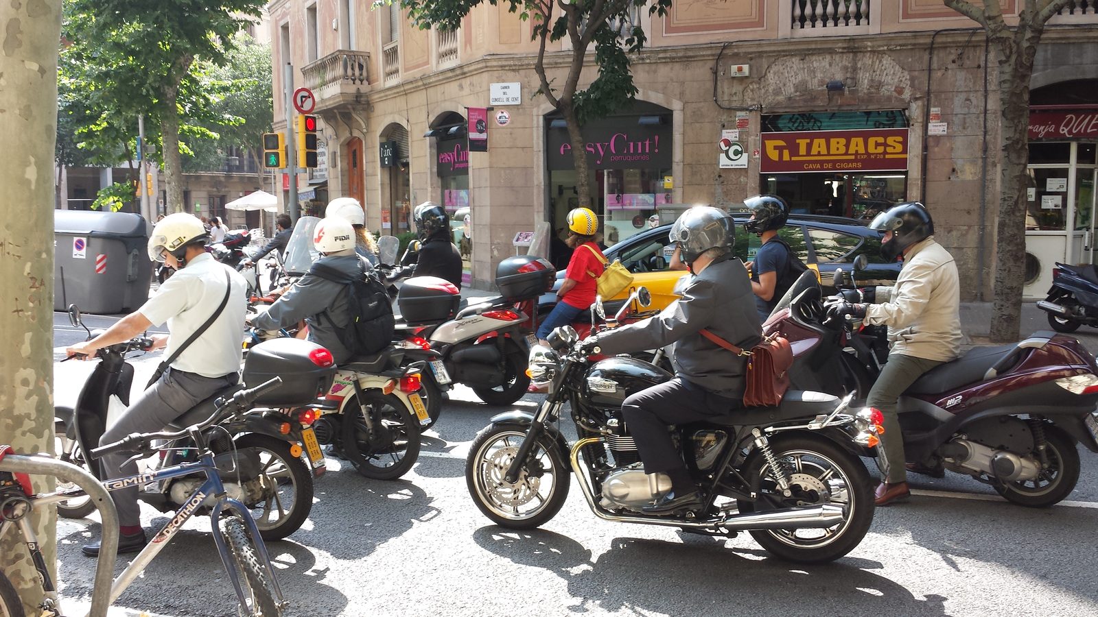 Scooters and motorcycles stopped in traffic near the hotel