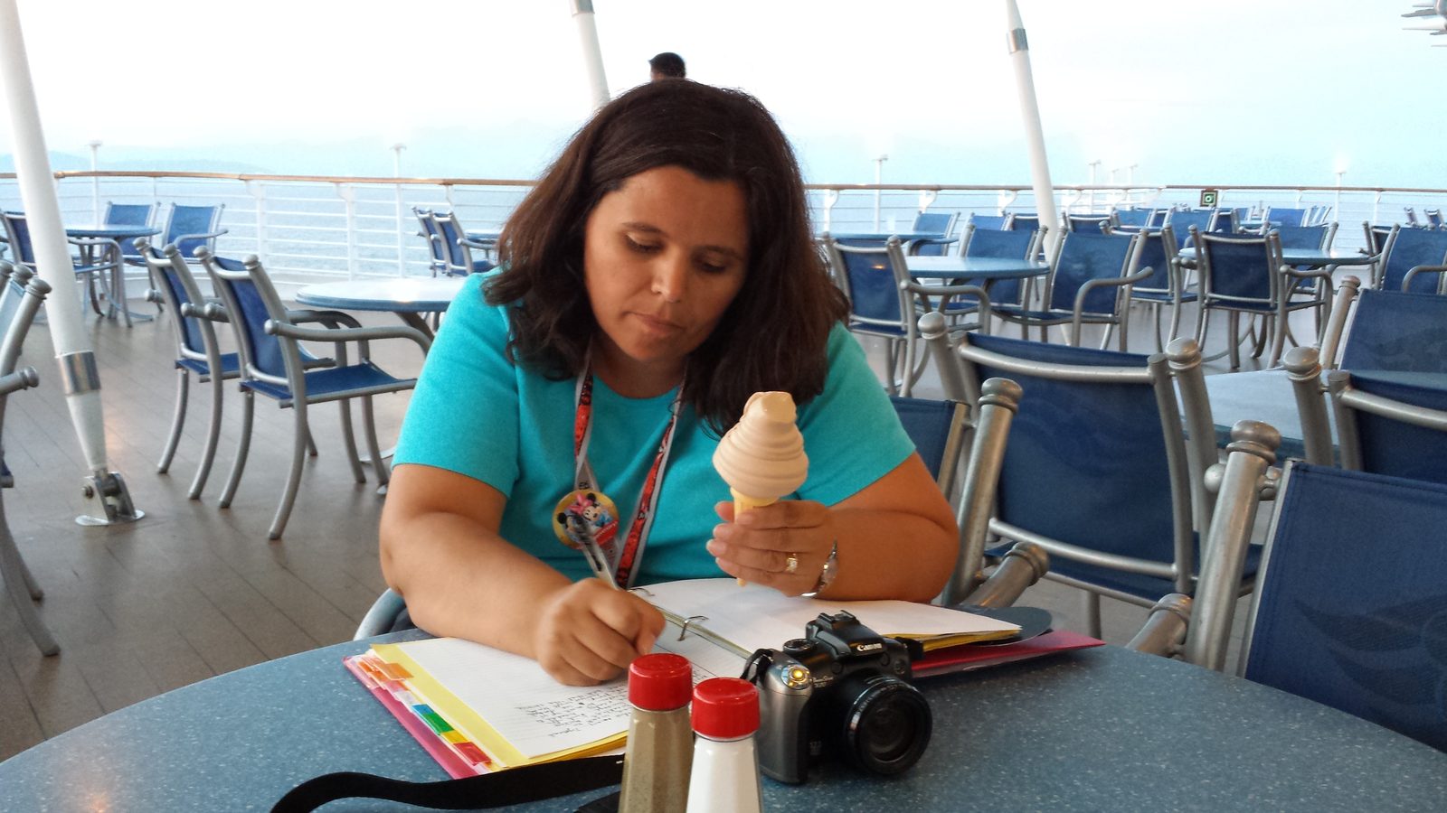 Kathy writing in her journal on deck