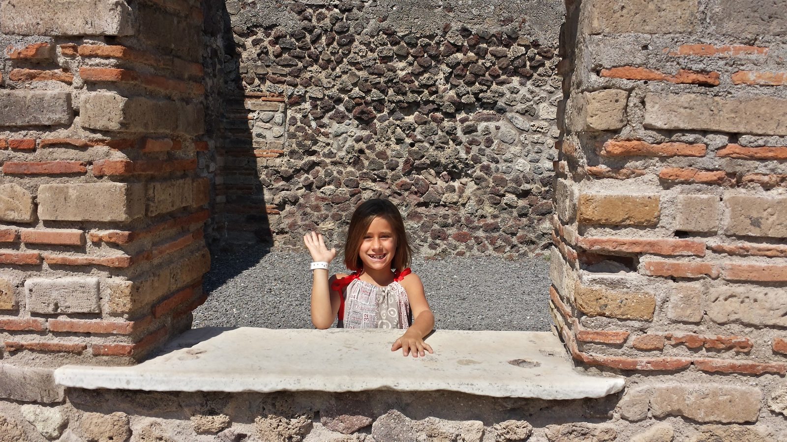 Lisa waving from a Pompeii doorway