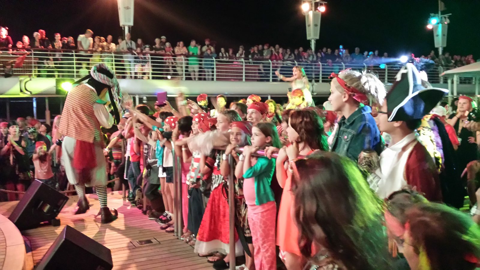 Goofy in pirate garb with the crowd at the Pirates in the Mediterranean deck party on Pirate Night