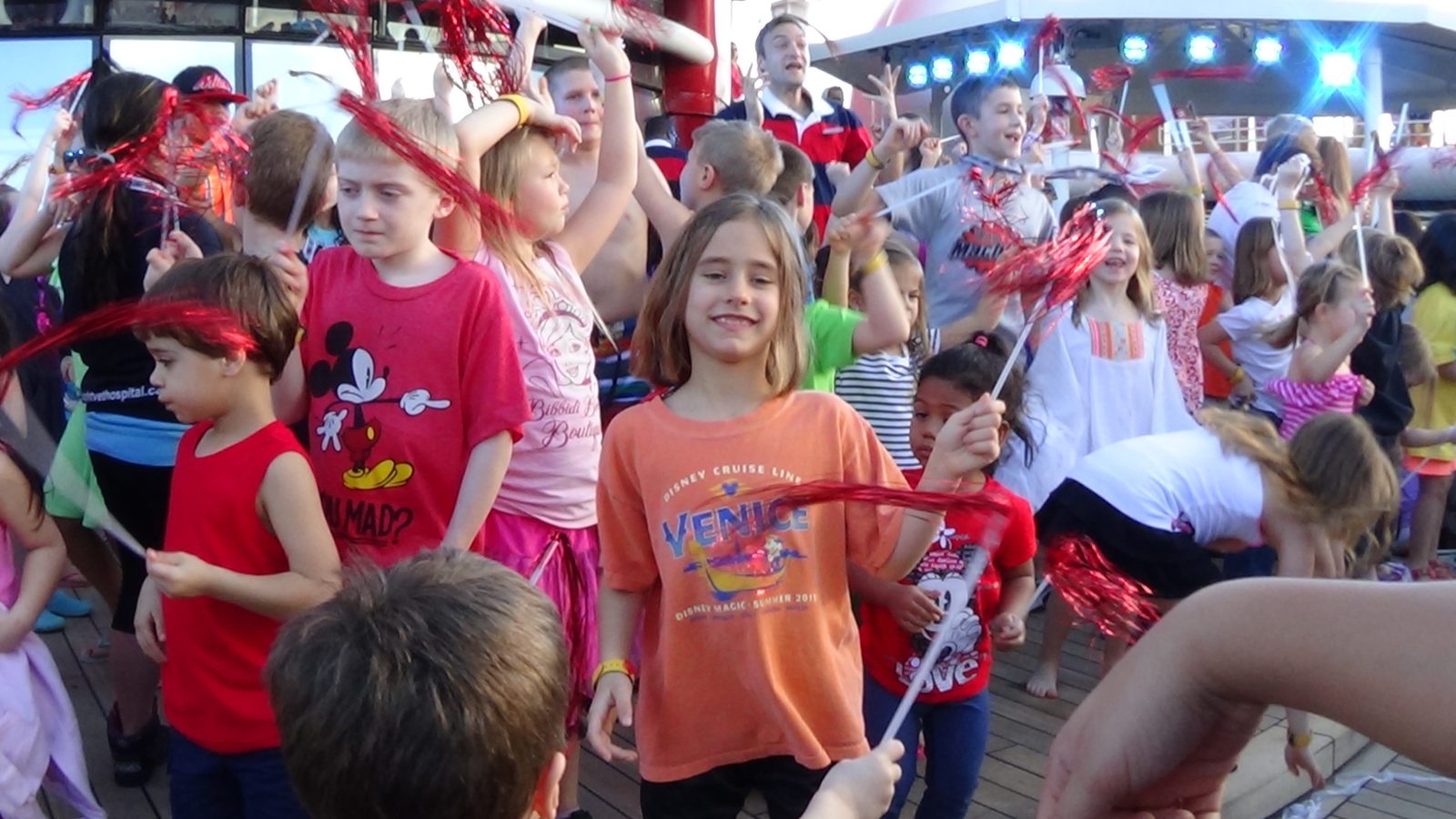 Lisa dancing with a red streamer at sail-away