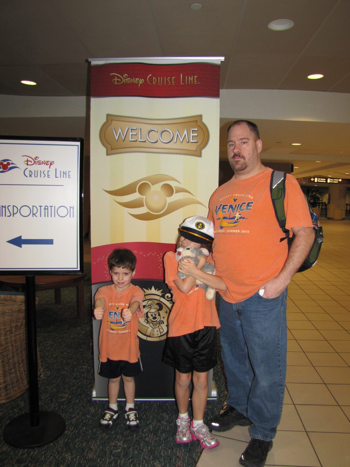 The kids and Michael at the Disney Cruise Line desk in Orlando